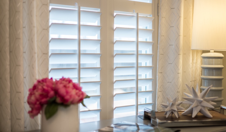 Plantation shutters by flowers in Raleigh